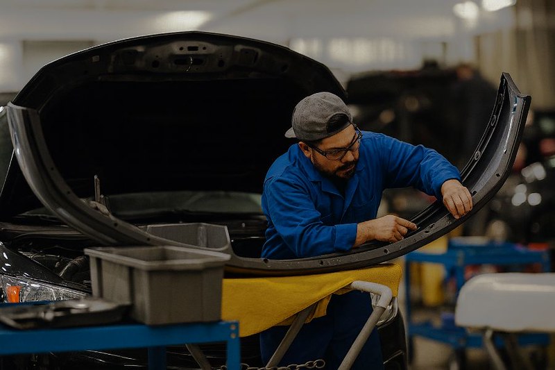 Technician working on bumper-JJ Auto Body Shop Technician working on bumper-JJ Auto Body Shop